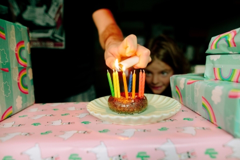 Birthday Candle Donut Being Lit By Parent